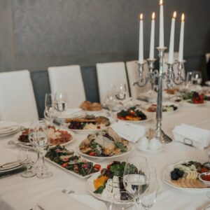 Luxurious table setup for a fine dining experience with candles and exquisite dishes, ideal for special occasions.