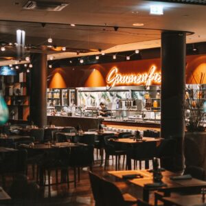 Warm and inviting interior of a stylish restaurant with empty tables and modern decor.